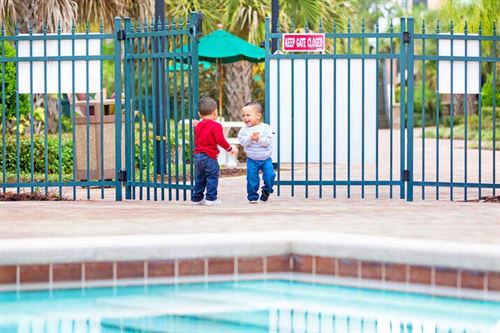 Two young boys standing next to a pool

AI-generated content may be incorrect.